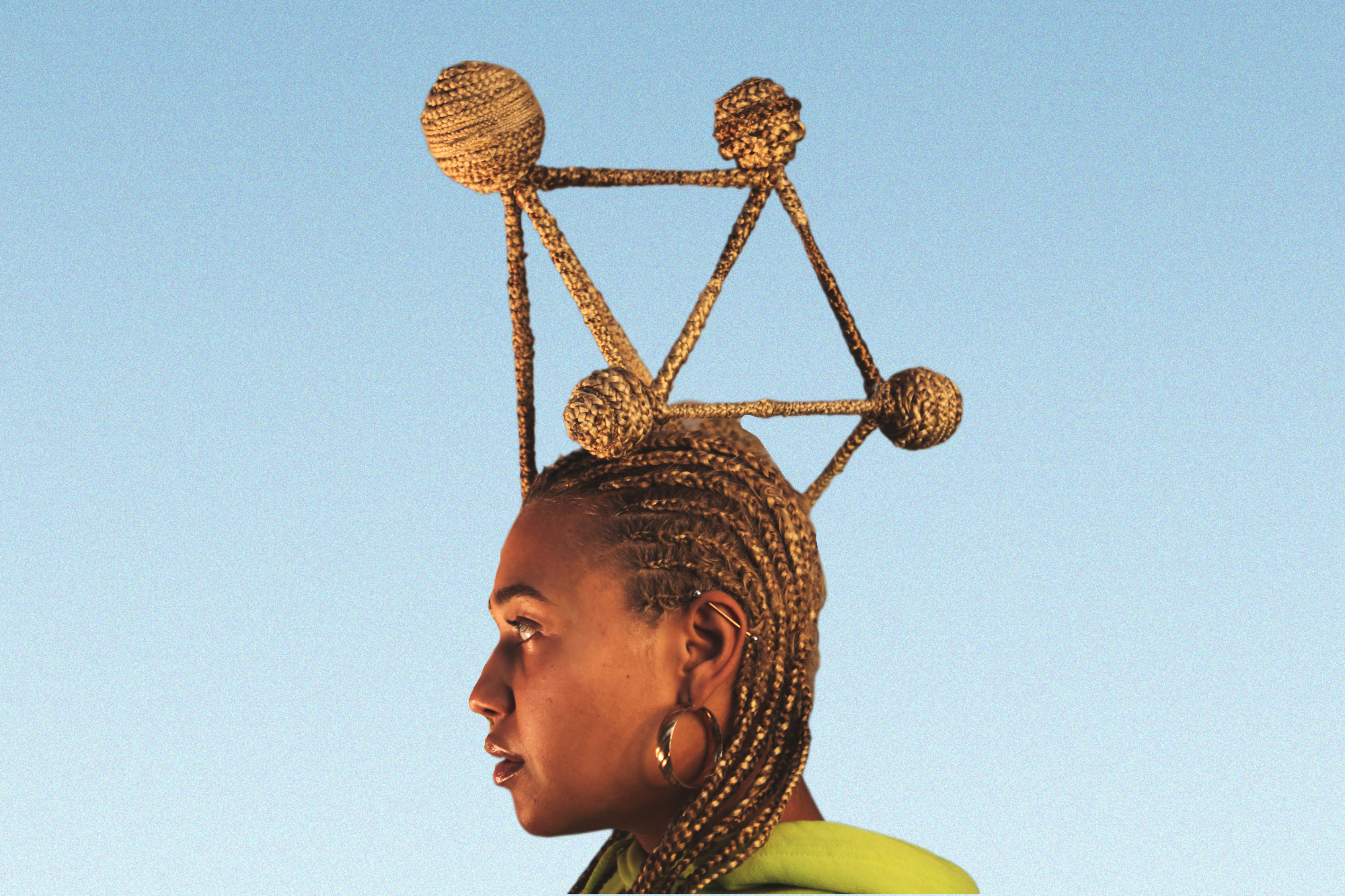  A young brown woman looking sideways to the left with cornrow hairstyle , the hairstyle has a brown/golden colour. On the cornrows , she has a braided structure made up of linear braids with spherical braids at the joints of the linear braids representing the craftwomanship/craftmanship and complexity within neural network. 